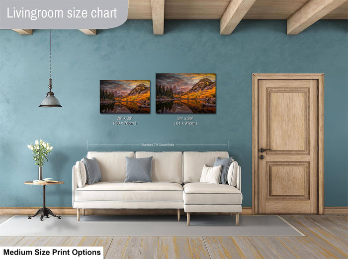 a living room with a white sofa, a wooden door, and a painting of a mountain landscape on the wall. The painting is of medium size, and the living room appears to be designed for a comfortable and relaxing atmosphere.