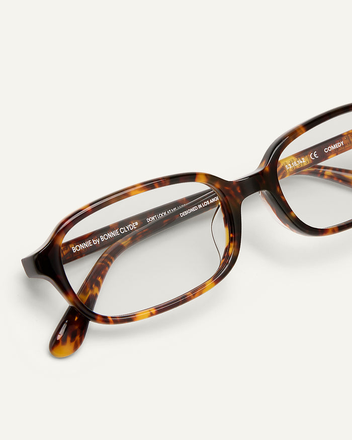 Close-up shot of Bonnie Clyde Comedy optical frames in tortoise with clear lenses.