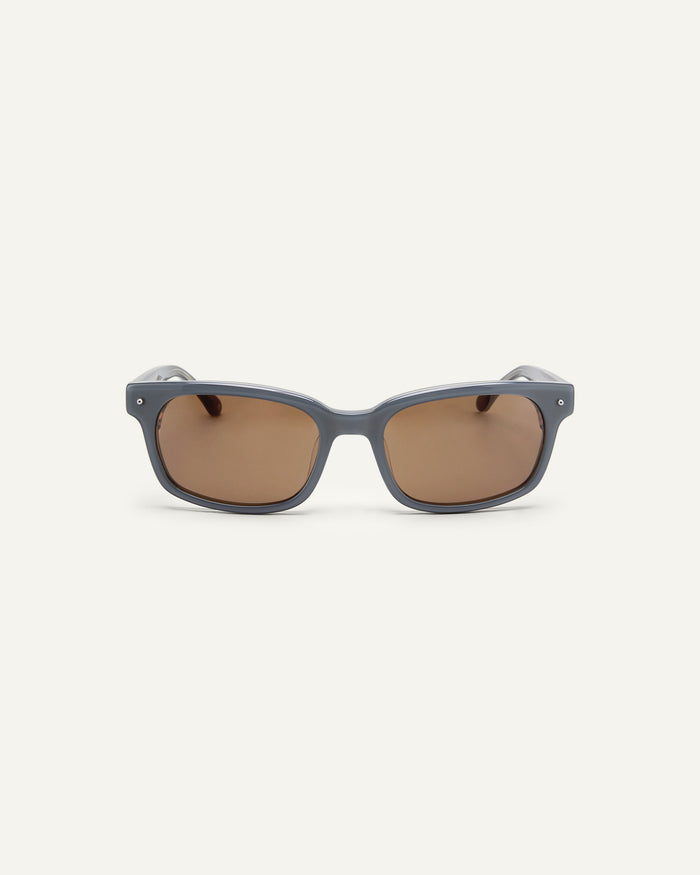 Face shot of Bonnie Clyde Dagger sunglasses in layered silver with brown lenses.