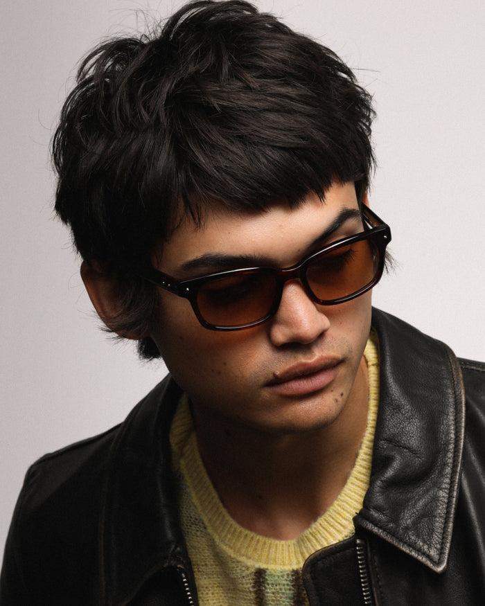 Quarter shot of Bonnie Clyde Dagger sunglasses in red tortoise with brown lenses.