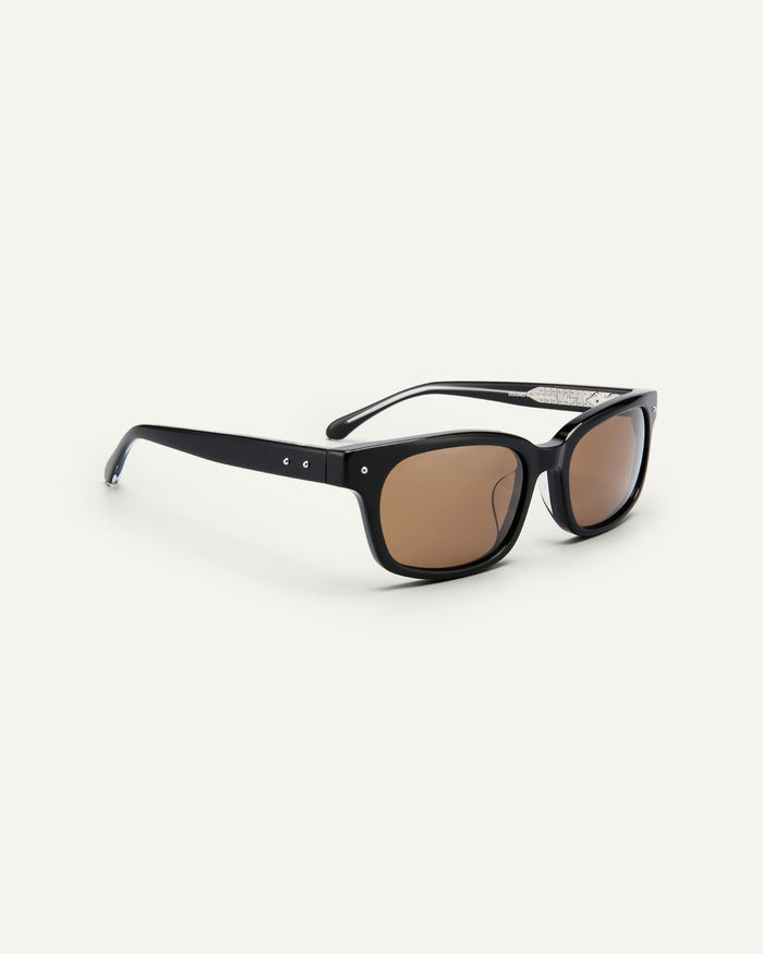 Side shot of Bonnie Clyde Dagger sunglasses in black with brown lenses.