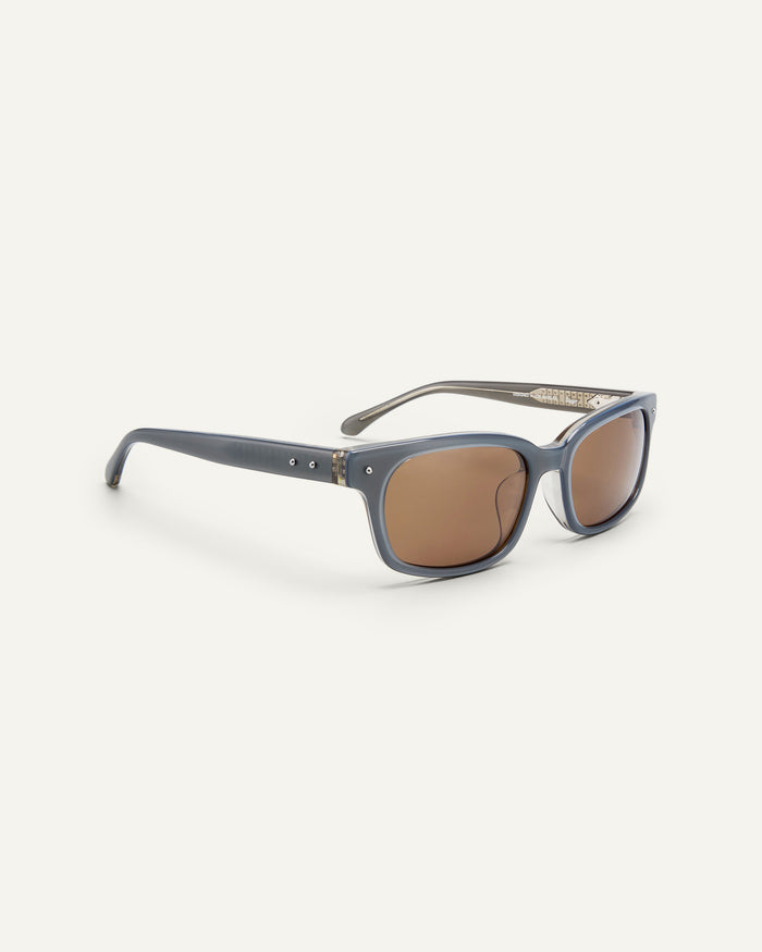Side shot of Bonnie Clyde Dagger sunglasses in layered silver with brown lenses.