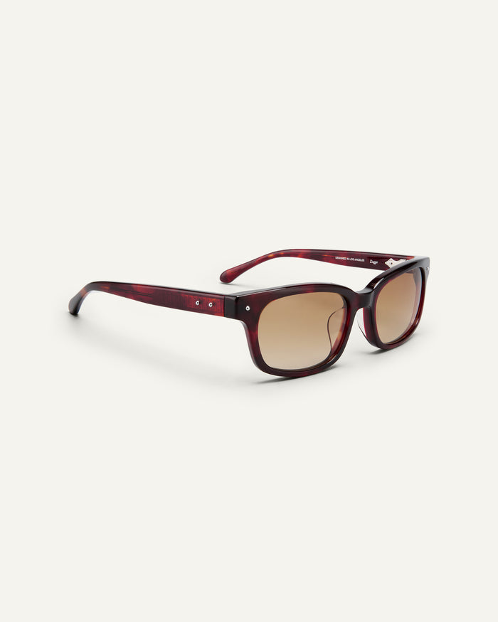 Side shot of Bonnie Clyde Dagger sunglasses in red tortoise with brown lenses.
