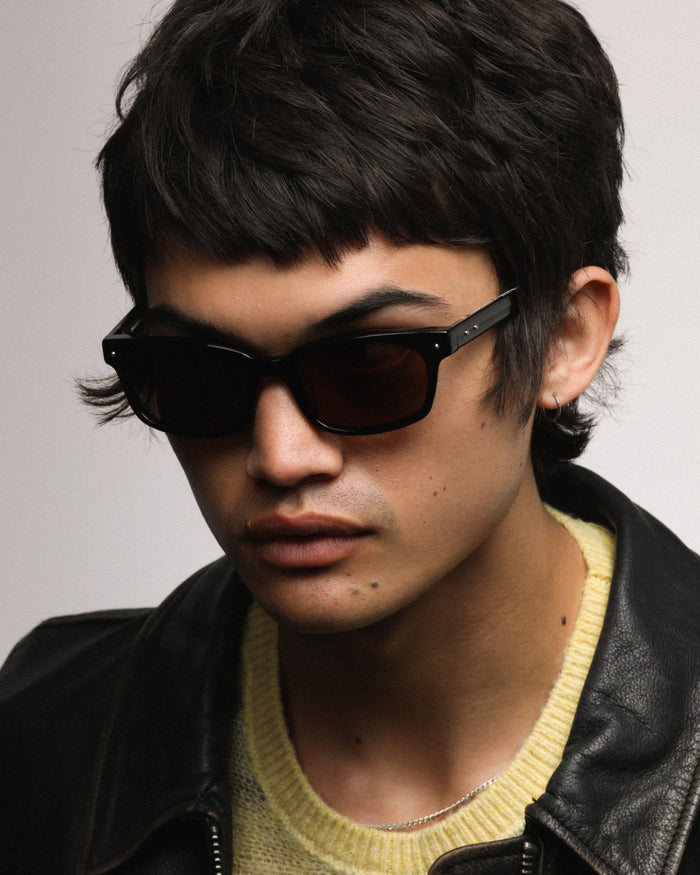 Close-up shot of Bonnie Clyde Dagger sunglasses in black with black lenses.