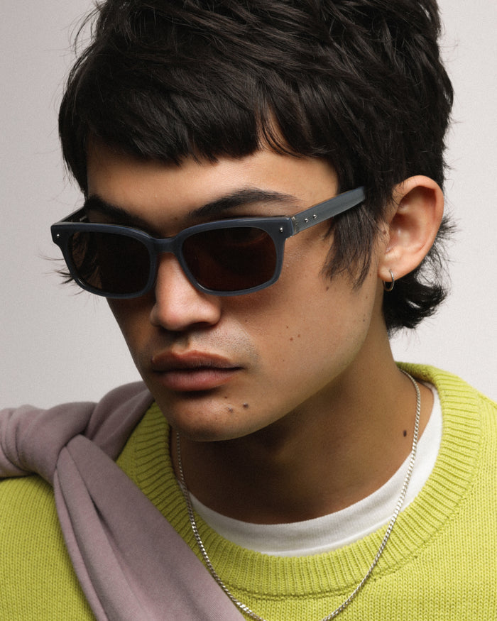 Close-up shot of Bonnie Clyde Dagger sunglasses in layered silver with brown lenses.