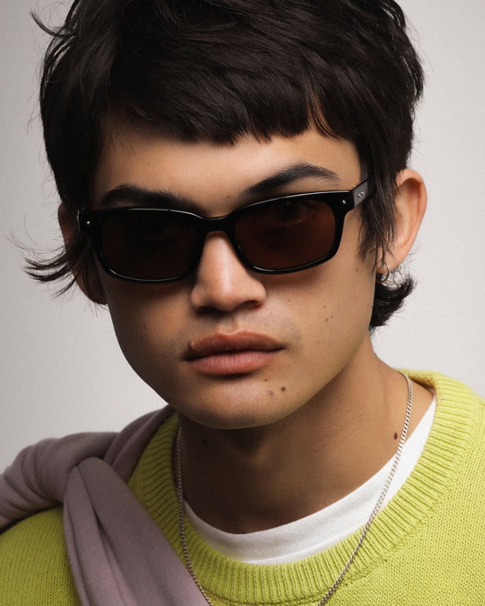 Close-up shot of Bonnie Clyde Dagger sunglasses in black with brown lenses.
