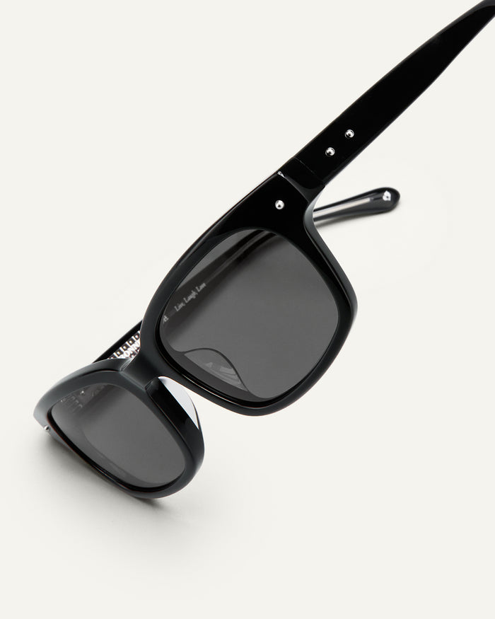 Detail shot of Bonnie Clyde Dagger sunglasses in black with black lenses.