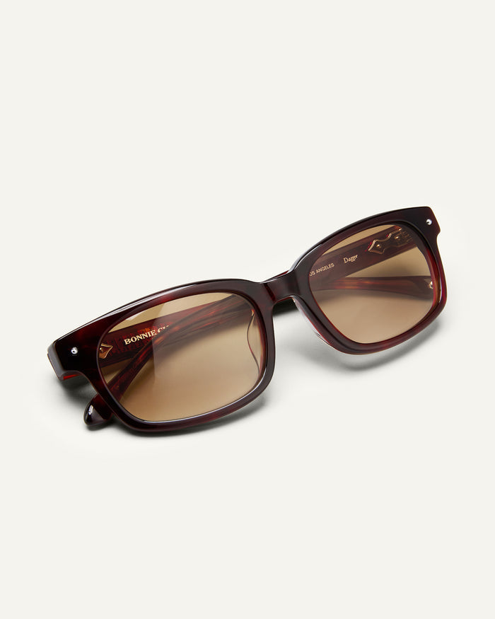 Additional view of Bonnie Clyde Dagger sunglasses in red tortoise with brown lenses.