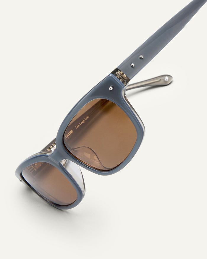 Additional view of Bonnie Clyde Dagger sunglasses in layered silver with brown lenses.