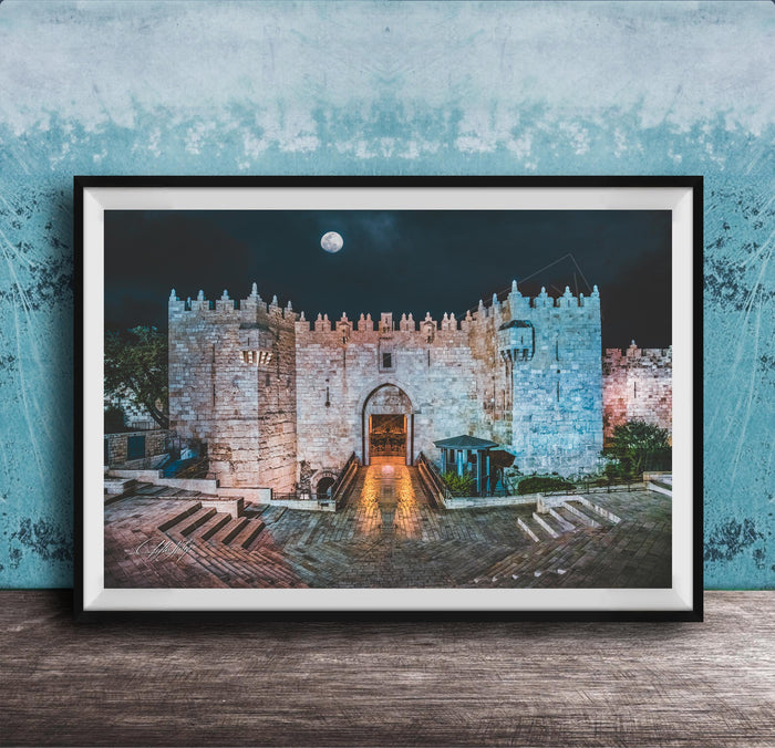 a castle with a moonlit night scene, featuring a large archway leading to a tower.