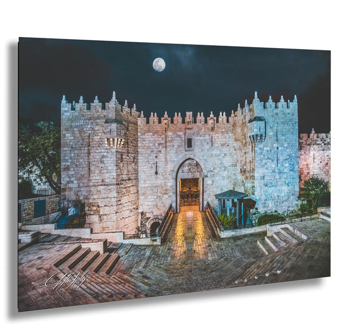 a large, imposing stone castle with a prominent archway entrance, set against a dark sky with a full moon.