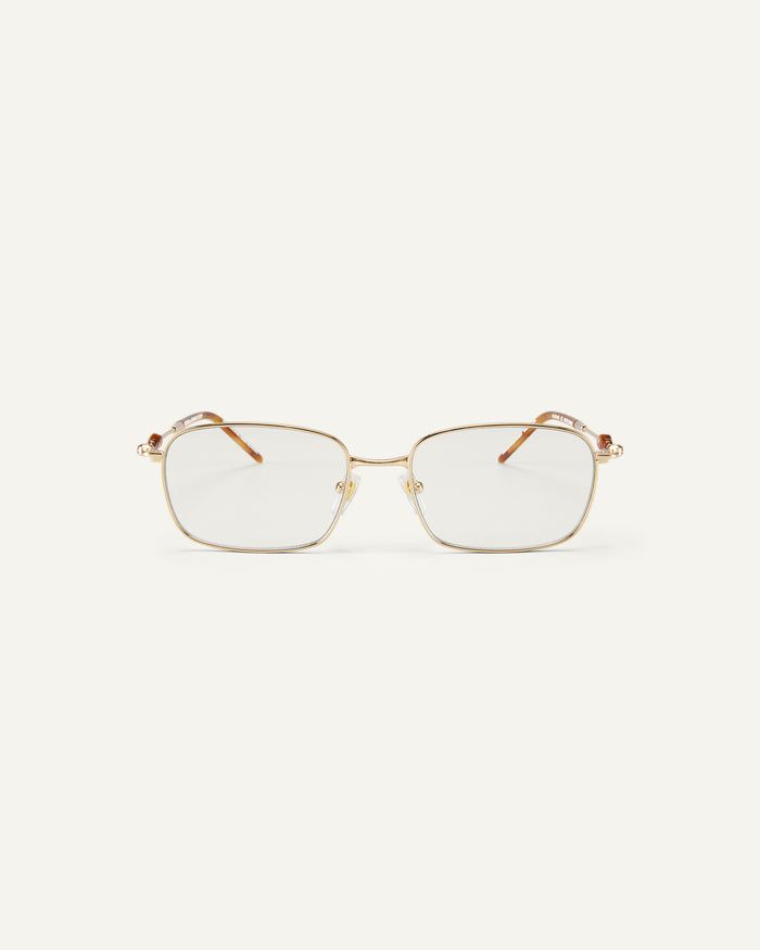 Face shot of Bonnie Clyde Dance Dance optical frames in gold and yellow tortoise with clear lenses.