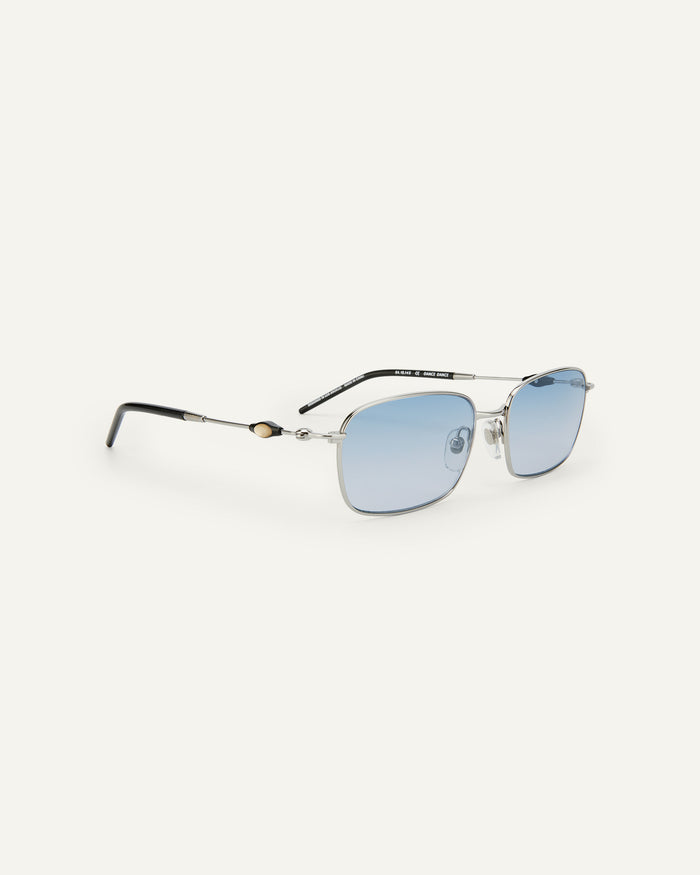 Quarter shot of Bonnie Clyde Dance Dance sunglasses in silver and black with blue gradient lenses.