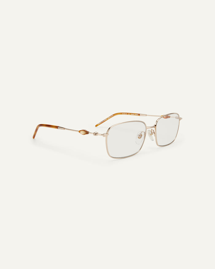 Side shot of Bonnie Clyde Dance Dance optical frames in gold and yellow tortoise with clear lenses.