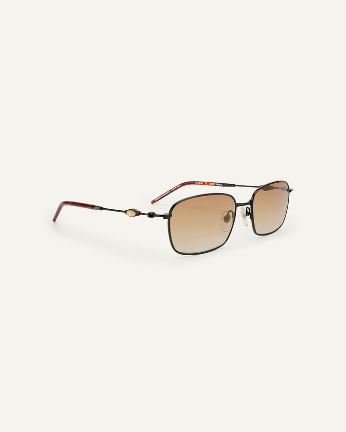 Side shot of Bonnie Clyde Dance Dance sunglasses in black and red tortoise with brown gradient lenses.