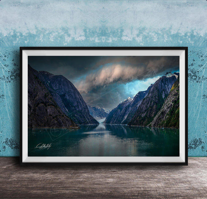 a serene landscape with a calm lake surrounded by towering mountains under a dramatic cloudy sky.