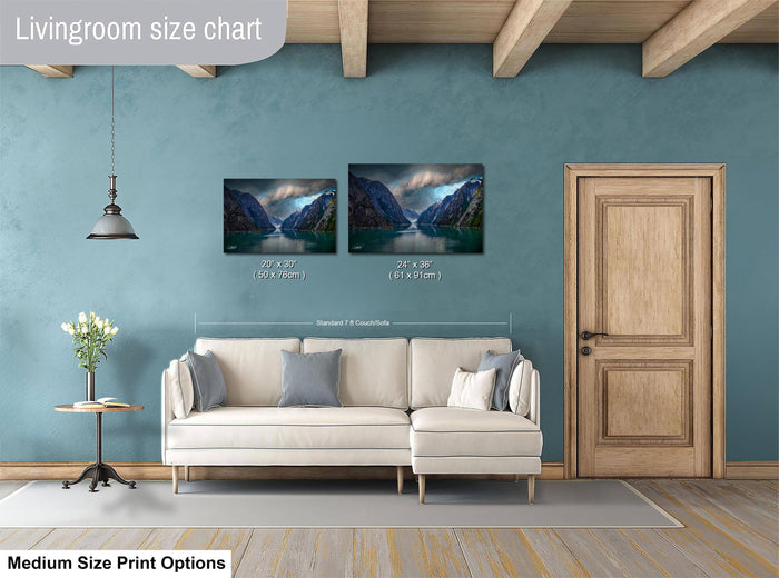 a living room with a white sofa, a wooden door, and a painting of a mountain landscape on the wall.