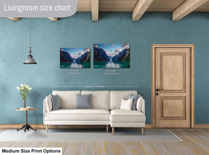 a living room with a white sofa, a wooden door, and a painting of a scenic landscape on the wall.