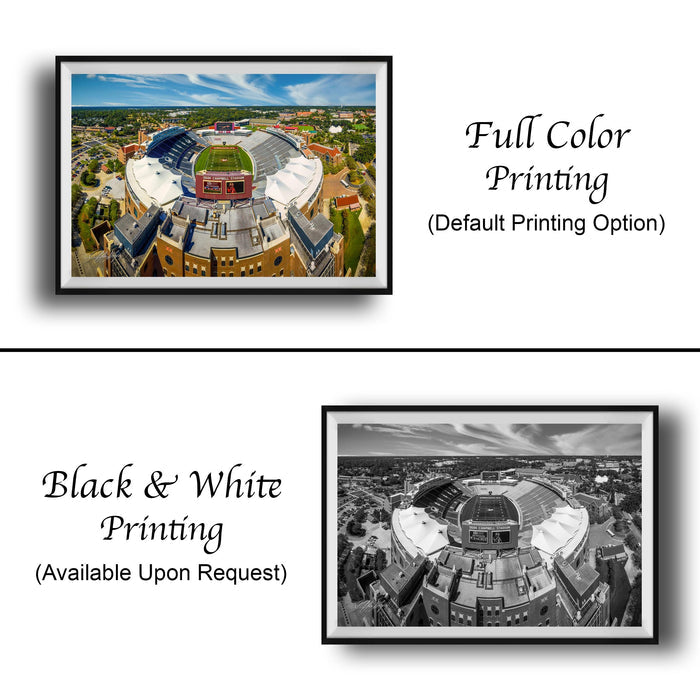 The image is a collage of two framed pictures. The left frame is a full color print, while the right frame is a black and white print. Both frames depict the same cityscape, featuring a large stadium or arena in the center. The text on the image indicates that the full color print is available upon request, and the black and white print is not.