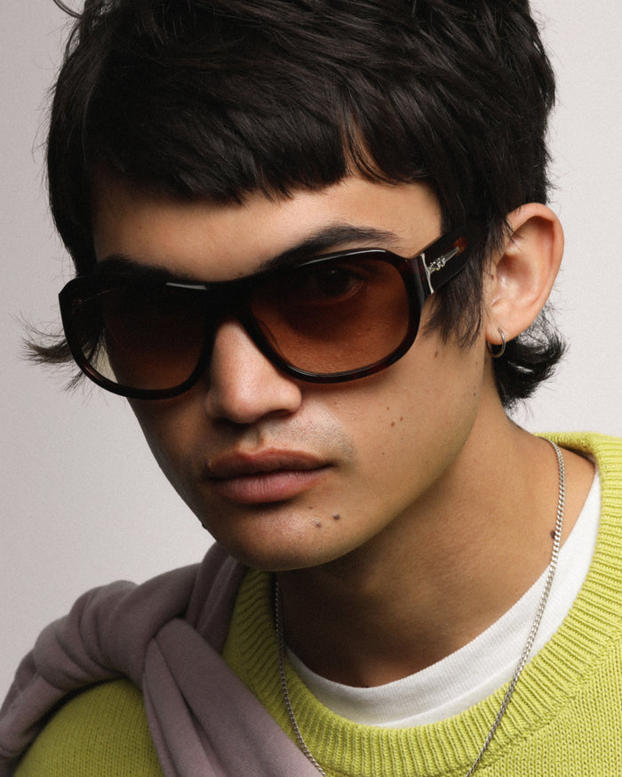 Quarter shot of Bonnie Clyde Dog sunglasses in red tortoise with brown gradient lenses.