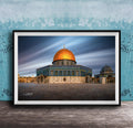 a large, ornate building with a golden dome, possibly a mosque or a significant historical structure, set against a blue sky with wispy clouds.