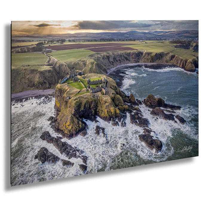 a picturesque coastal scene with a castle perched atop a rocky outcrop, overlooking the crashing waves of the sea.