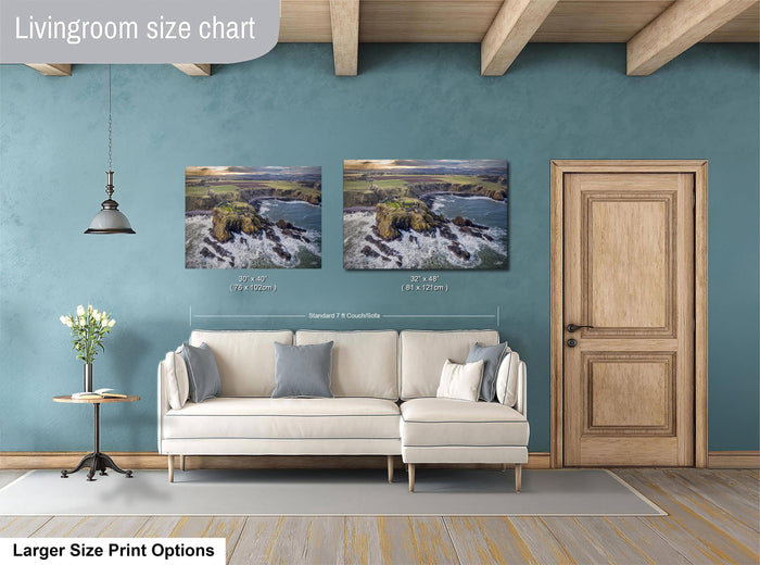 a living room with a white sofa, a wooden door, and a painting of a coastal landscape on the wall.