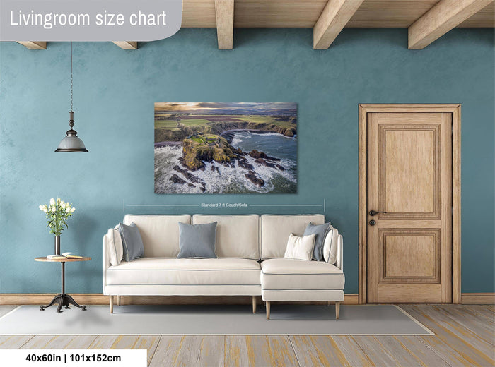 a living room with a large painting of a coastal landscape hanging on the wall. The painting is framed and appears to be of a significant size, as indicated by the text "40x60in | 101x152cm". The room has a white sofa and a wooden door, creating a cozy and inviting atmosphere.