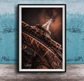 a close-up view of the Eiffel Tower, showcasing its intricate metal lattice structure and the surrounding night sky.