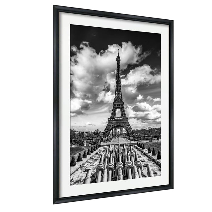 The image is a black and white photograph of the Eiffel Tower in Paris, France.