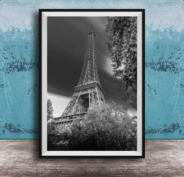 A black and white photograph of the Eiffel Tower in Paris, France, with a blue and white background.