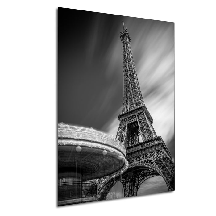 A black and white photograph of the Eiffel Tower in Paris, France, with a blurred background.