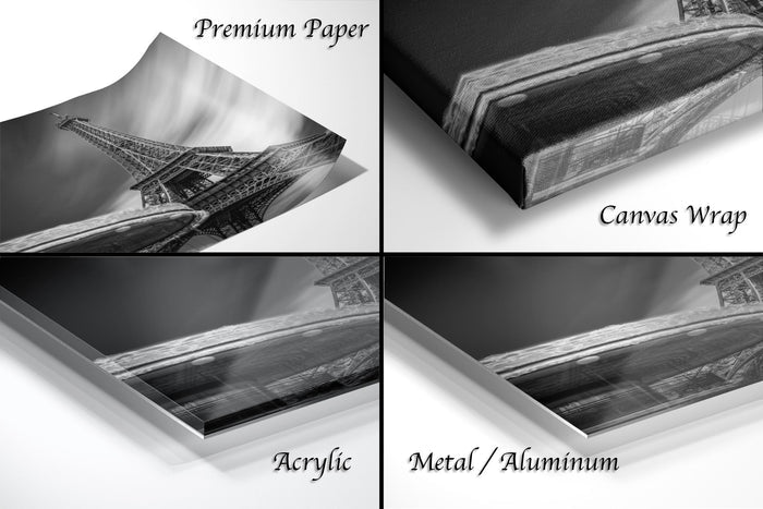 The image is a collage of four different photographs depicting the Eiffel Tower, with each photograph labeled with the appropriate material used to print it: "Premium Paper", "Canvas Wrap", "Acrylic", and "Metal/Aluminum".