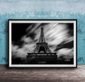 A framed black and white photograph of the Eiffel Tower, a famous landmark in Paris, France.