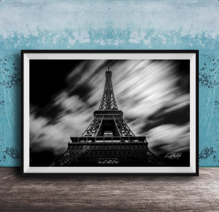 A framed black and white photograph of the Eiffel Tower, a famous landmark in Paris, France.