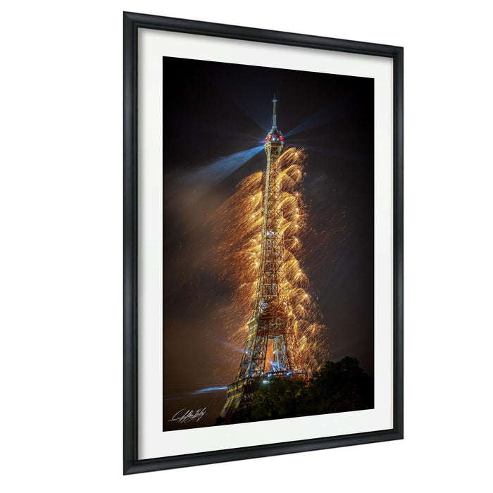 a tall tower with a bright light at the top, surrounded by a shower of sparks or firework-like effects, creating a visually striking and dynamic scene.