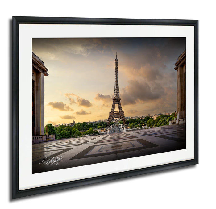 the Eiffel Tower, a famous landmark in Paris, France, with a cloudy sky in the background.