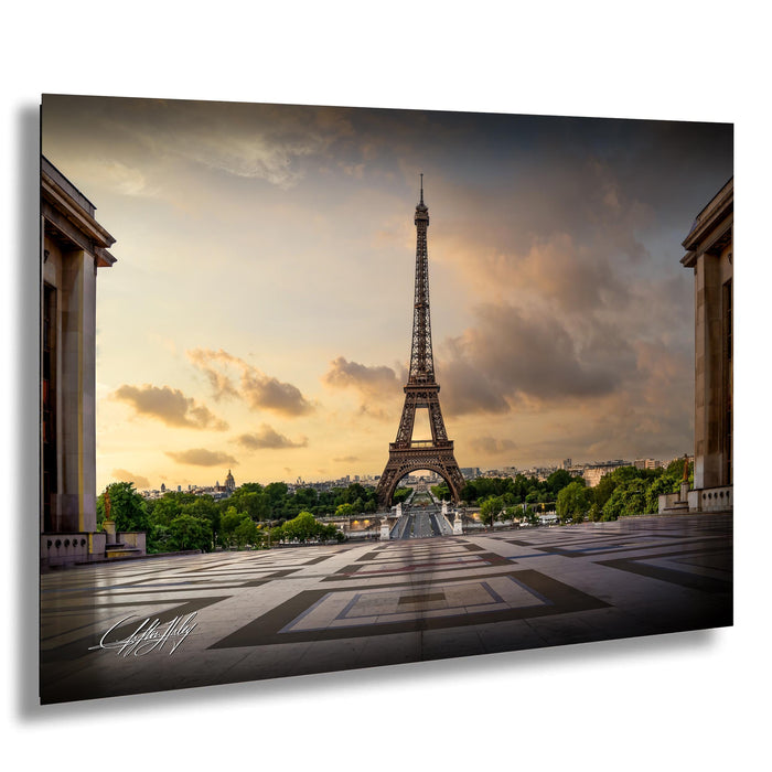 the Eiffel Tower, a famous landmark in Paris, France, with a dramatic sky in the background.