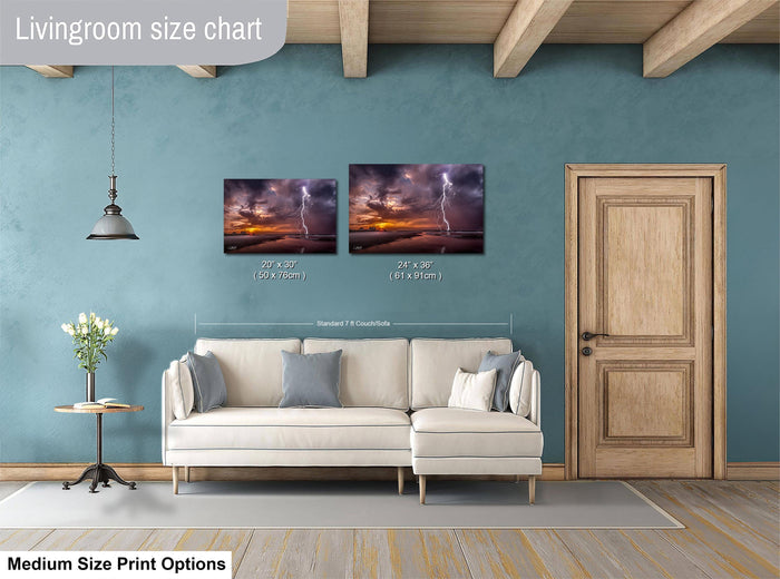 a living room with a white sofa, a wooden door, and a painting of a stormy sky on the wall.