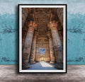 an ancient Egyptian temple with towering columns and intricate carvings, set against a blue wall with a textured pattern.