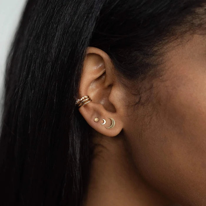 Everyday Larger Crescent Moon Earring in 14k yellow gold, shown worn on hand