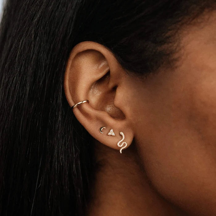 Everyday Little Crescent Moon Earring in 14k yellow gold, shown worn on hand