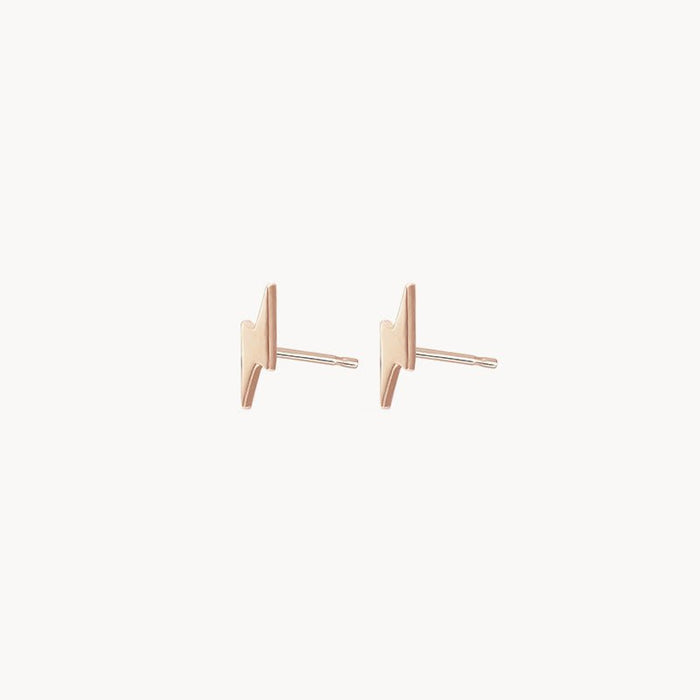 A pair of Everyday Little Lightning Bolt Earrings by bluboho, crafted in 14k yellow gold, featuring a minimalist design against a white background. The posts are thin and straight, accentuating the sleek and modern aesthetic of these earrings.