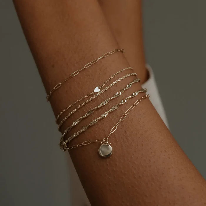 Everyday Little Lovely Heart Bracelet in 14k yellow gold, shown worn on hand