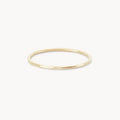 The Faceted Felicity stacking ring in 10k yellow gold by bluboho is showcased against a plain white background. This minimalist and elegant ring features a slightly polished finish, making it perfect for various occasions.