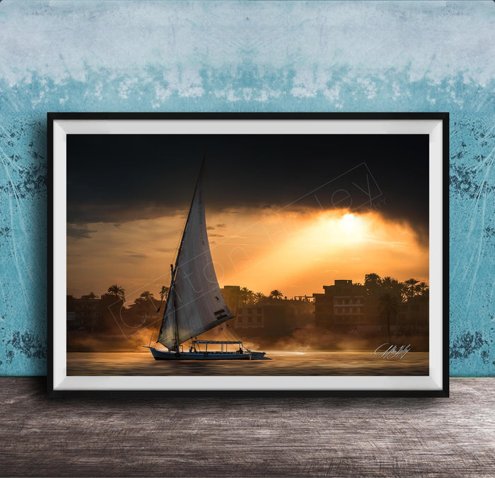felucca sailboat art, nile river sunset print, luxor egypt fine art, egypt river photography, luxury travel wall art, serene river landscape, egyptian culture artwork, nile boat photography, sunset fine art print, timeless travel decor, historic river wall art, luxury collector photography, egypt fine art print, calming interior artwork
