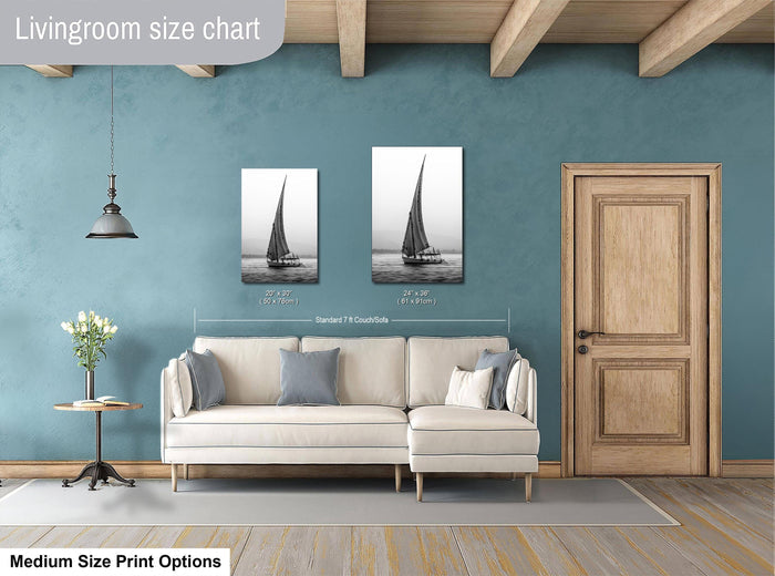 This luxury black and white fine art photograph captures a felucca sail boat drifting along the Nile River at sunset near Luxor, Egypt. Soft fog and minimalist composition create a timeless, monochrome aesthetic rooted in Egyptian river culture. Ideal for collectors and interior designers seeking refined, museum-quality wall art that embodies elegance, simplicity, and enduring calm.
