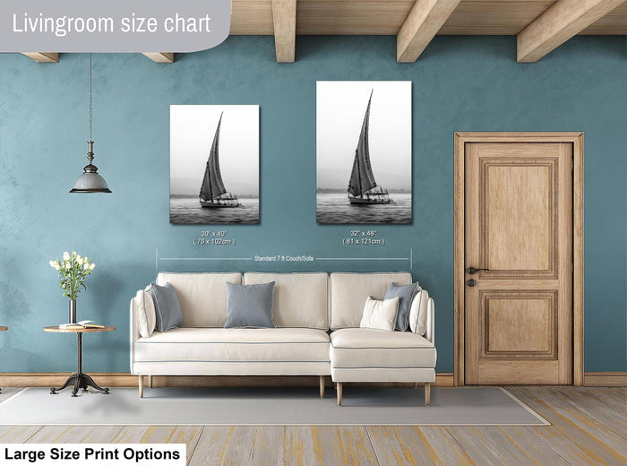 This luxury black and white fine art photograph captures a felucca sail boat drifting along the Nile River at sunset near Luxor, Egypt. Soft fog and minimalist composition create a timeless, monochrome aesthetic rooted in Egyptian river culture. Ideal for collectors and interior designers seeking refined, museum-quality wall art that embodies elegance, simplicity, and enduring calm.