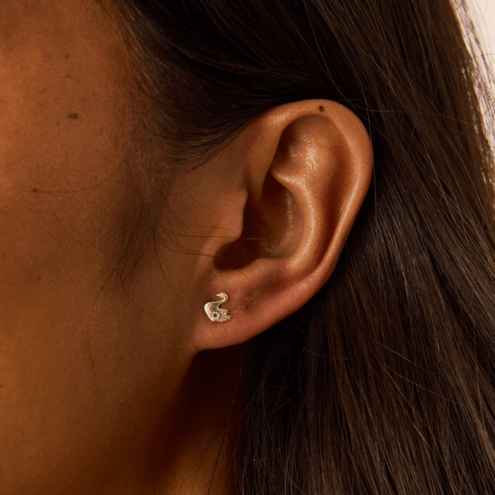 Floating Swan Studs in 14k yellow gold with blue sapphire, alternate angle detail view