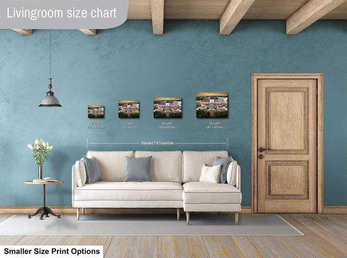 a living room with a white sofa, a wooden door, and a hanging light fixture. There are four framed prints of different sizes displayed on the wall, indicating the available print options for the room.